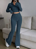 Woman wearing a blue ribbed knit cropped top and flared pants set