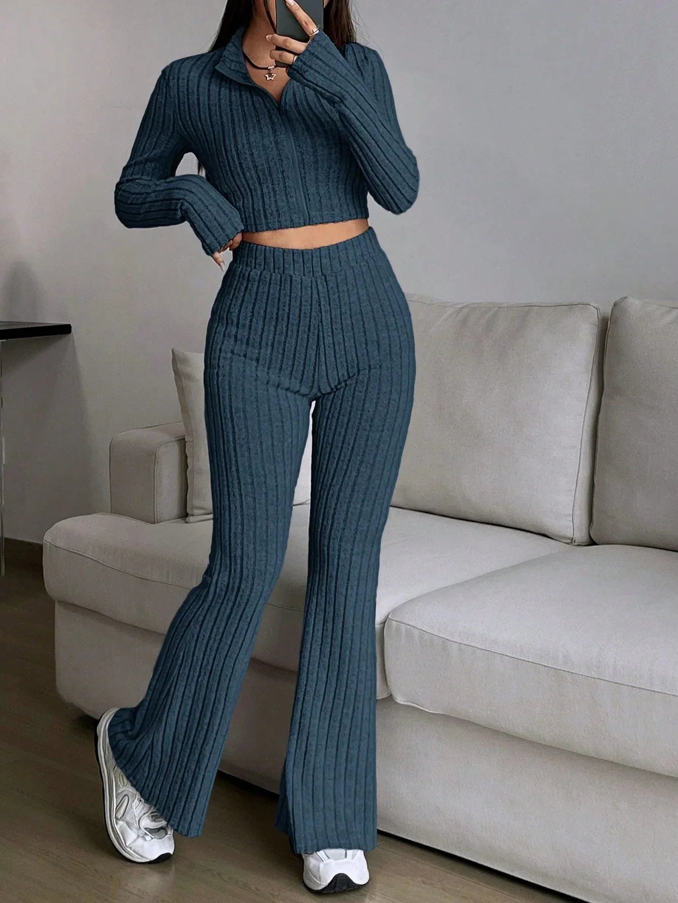 Woman wearing a blue ribbed knit cropped top and flared pants set