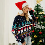 Close-up of a woman's face and shoulders wearing a dark blue Christmas sweater with a Santa Claus print.