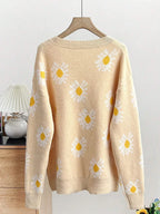 Back view of a light yellow long-sleeve cardigan with white daisy print, displayed on a hanger.