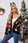 Woman wearing an open black Christmas print cardigan, showing a white crop top underneath.