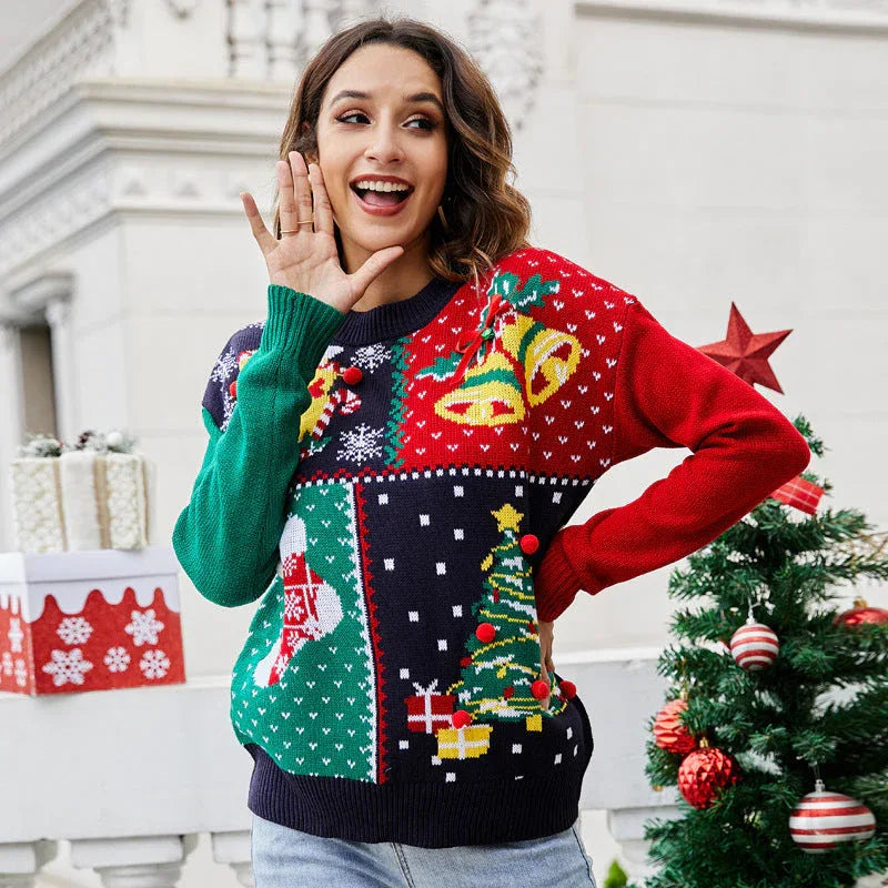 Detail of 3D red pom-poms on a holiday patchwork sweater.