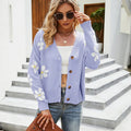 Woman wearing a light purple floral print knit cardigan with a v-neck and button-down closure.