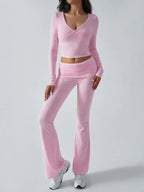 Close-up of pink knit crop top and flared pants