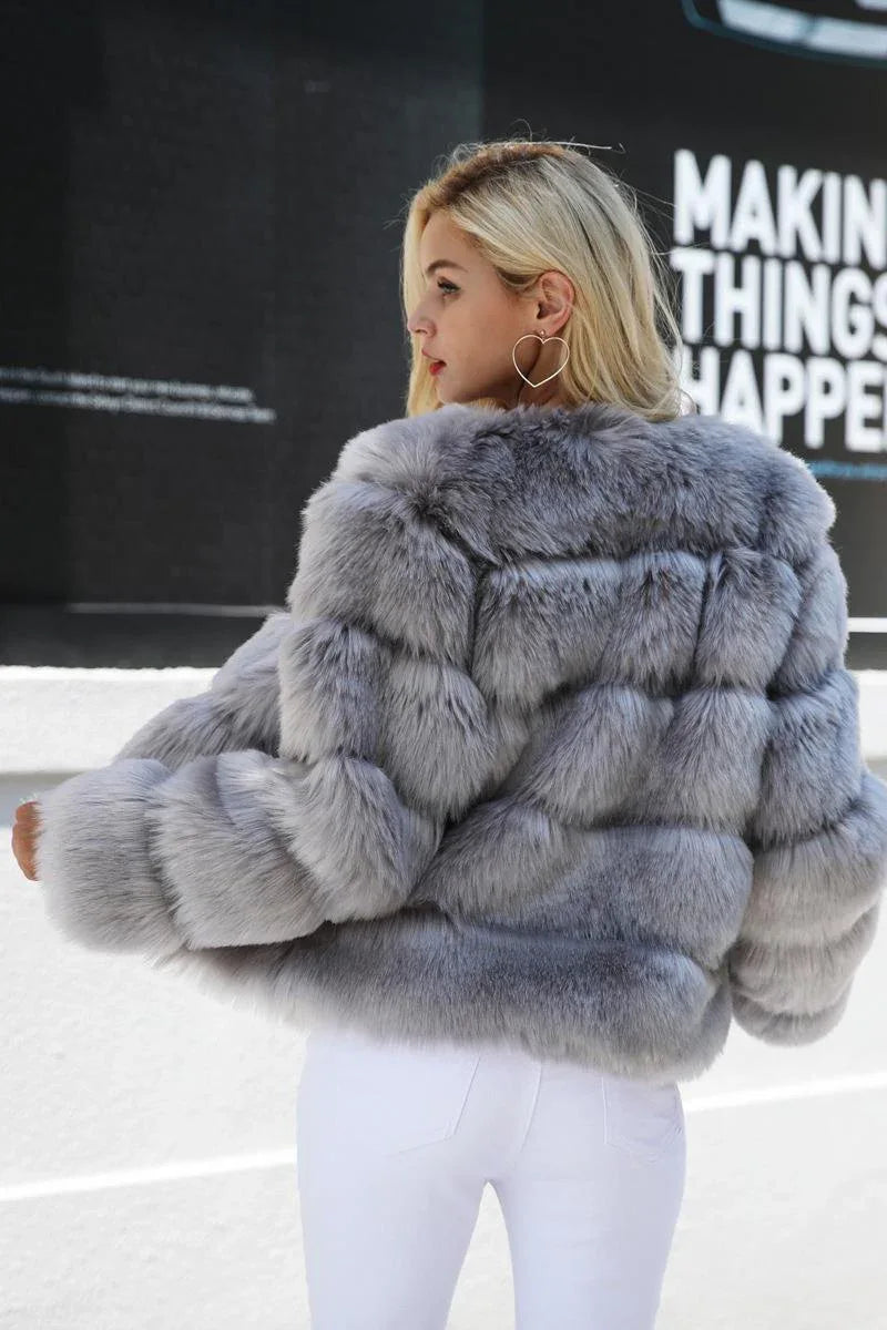 Back view of a woman wearing a grey faux fur jacket