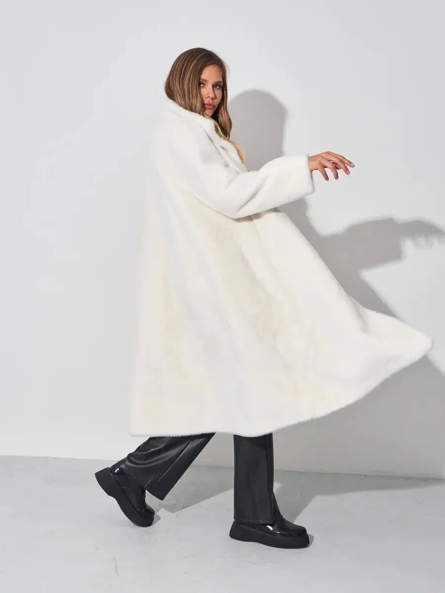 Woman twirling in a white faux fur long coat.