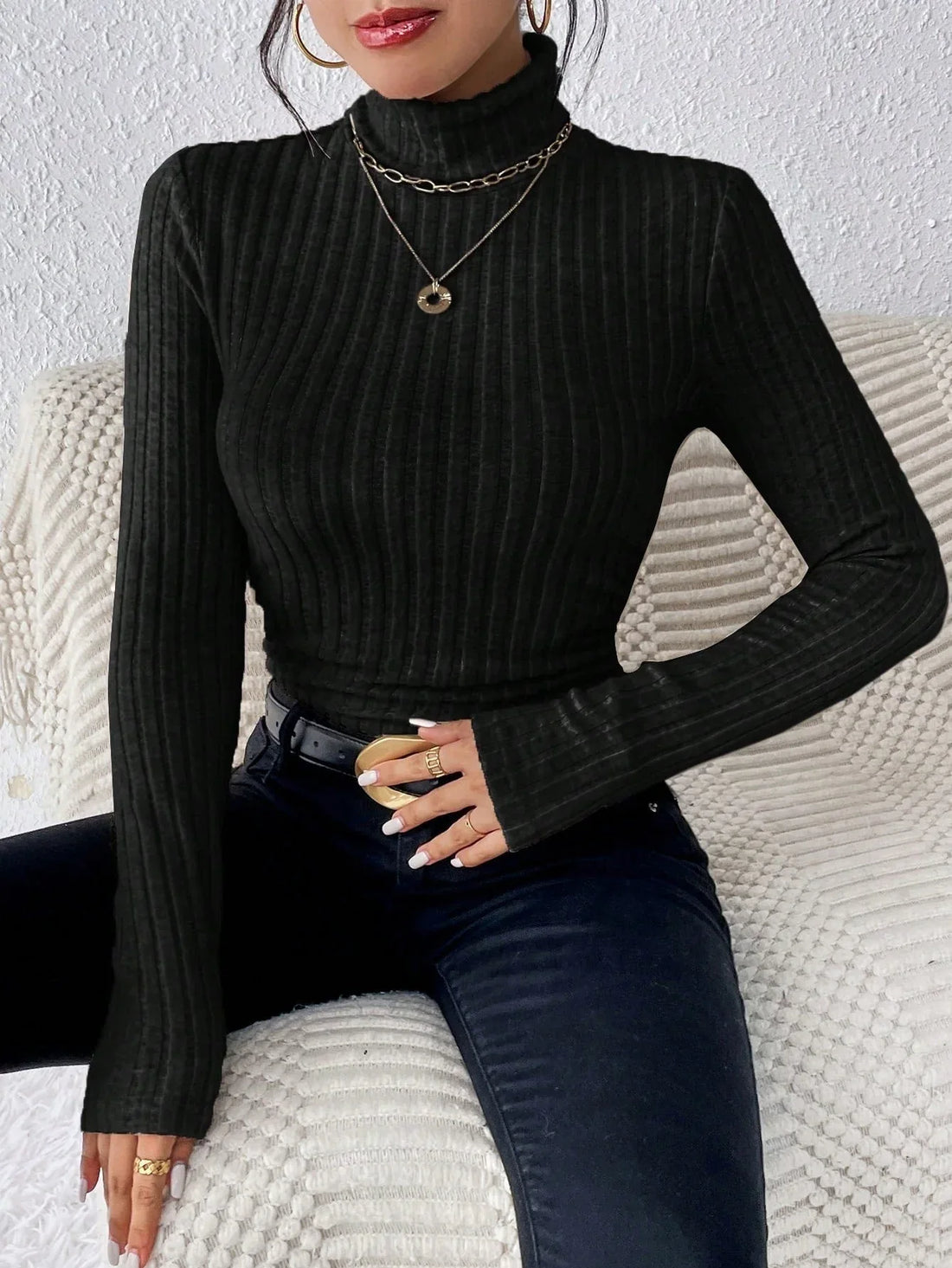 Woman wearing a black ribbed turtleneck top