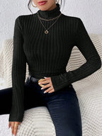Woman wearing a black ribbed turtleneck top