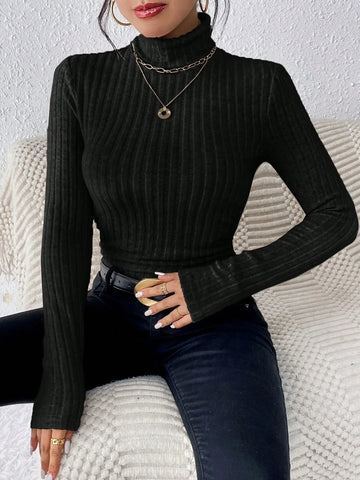 Woman wearing a black ribbed turtleneck top