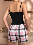 Back view of woman in black camisole and pink plaid shorts