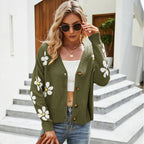 Woman wearing a green floral print knit cardigan with a v-neck and button-down closure.