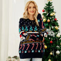 Full body shot of a woman in a navy blue Christmas sweater featuring Santa, trees, and candy canes.