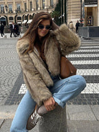Close-up of a woman wearing a brown faux fur jacket with a collared neckline and zipper closure.