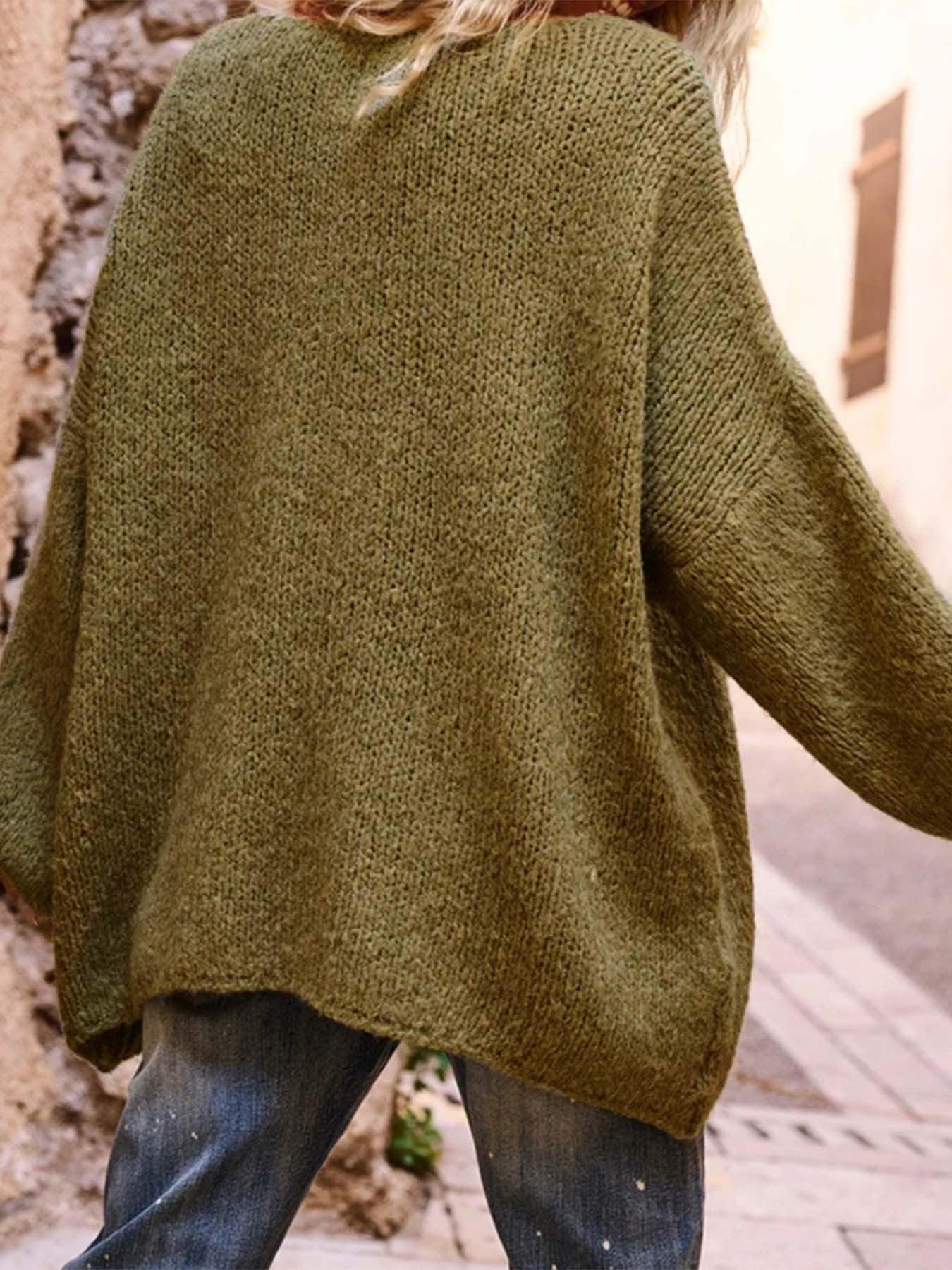Back view of the olive green knit sweater, highlighting the textured knit pattern and long sleeves.