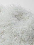 Close-up of cream shaggy faux fur texture