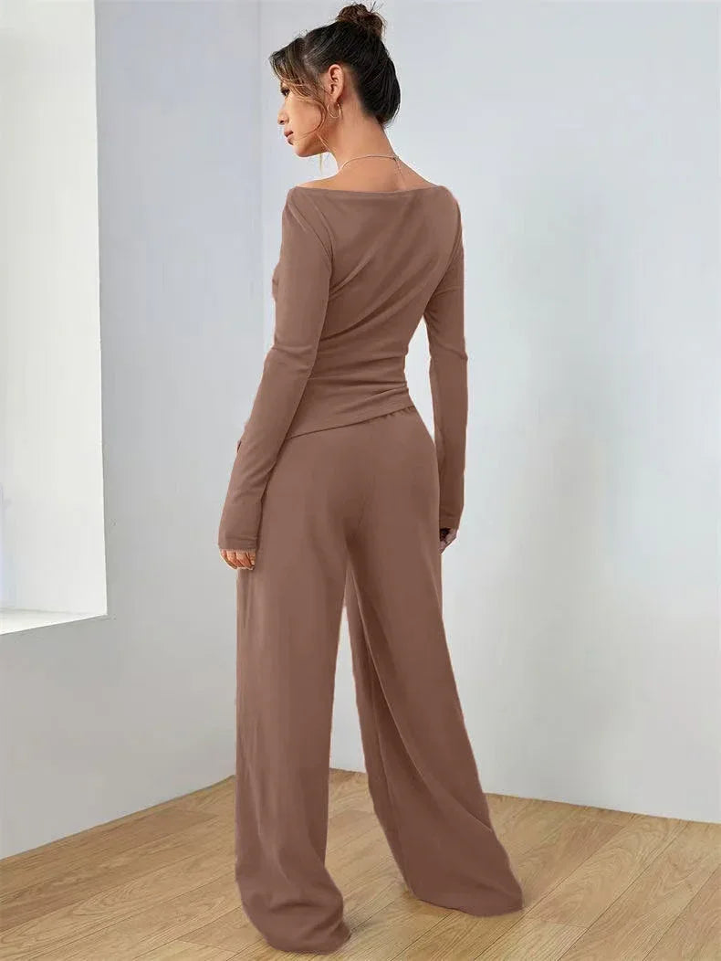 Woman wearing a brown boat neck long sleeve top with ruched waist and wide leg pants