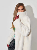 Close-up of a woman wearing a white faux fur coat and red gloves.