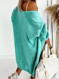 Rear view of a woman wearing a longline teal chunky knit cardigan, showing the oversized fit and drop shoulder.