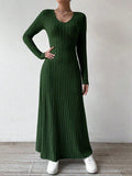 Model showing the v-neckline of a ribbed knit dress