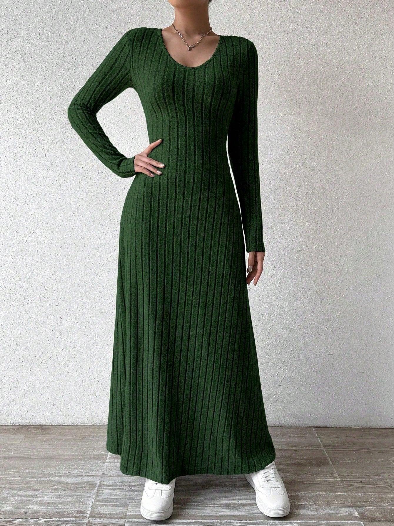 Model showing the v-neckline of a ribbed knit dress
