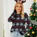 Woman holding a white clutch and wearing a red and white holiday sweater.