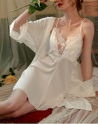 Close-up of the lace detail on the V-neck of a satin nightgown.