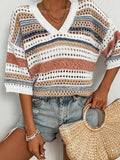 Close-up of a woman's torso showcasing the striped pattern and open knit texture of a cropped sweater.