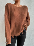 Woman wearing a rust-colored oversized distressed knit sweater