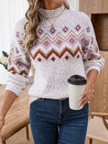 Close-up of a woman holding a coffee cup, wearing a white knit sweater with a geometric pattern.