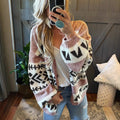 Woman wearing a pink, white, and black geometric pattern knit cardigan with balloon sleeves.