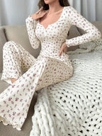 Woman sitting on sofa in floral print pajama set