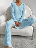 woman sitting on a chair wearing a light blue ribbed knit lounge set