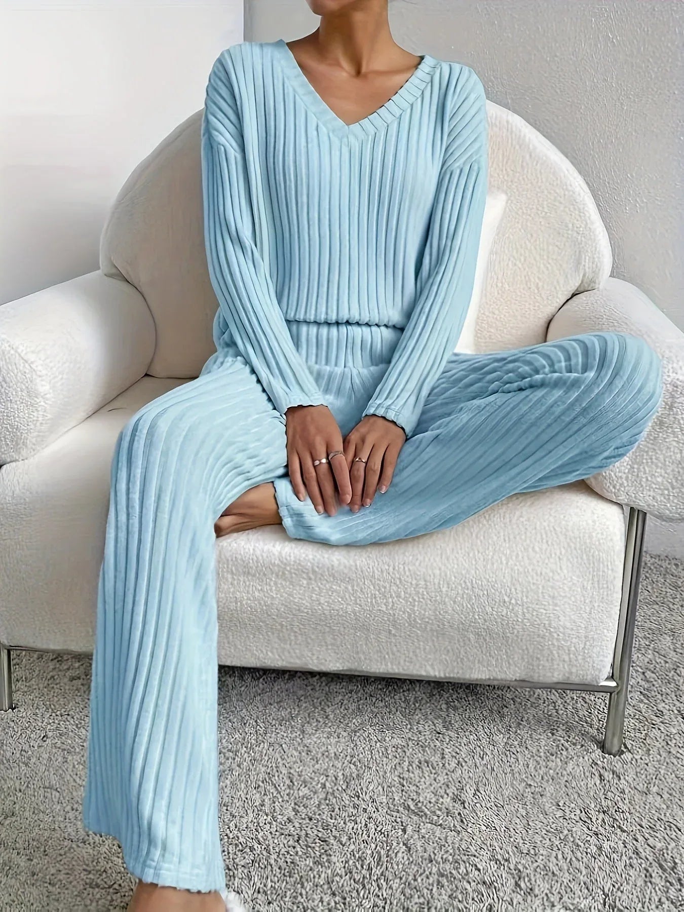 woman sitting on a chair wearing a light blue ribbed knit lounge set