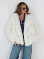 Close-up of a woman in a white faux fur jacket, showcasing the fabric texture and button details.