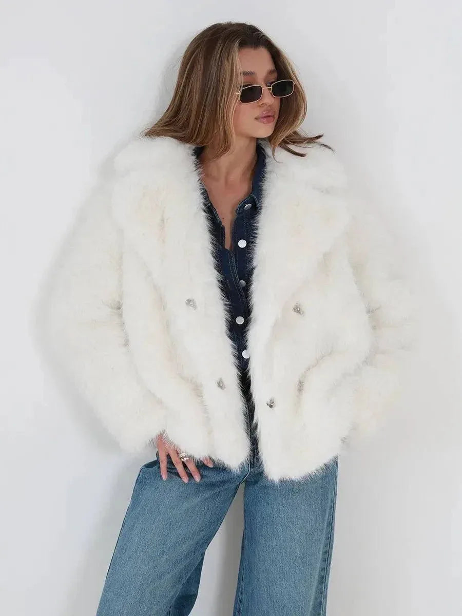 Close-up of a woman in a white faux fur jacket, showcasing the fabric texture and button details.