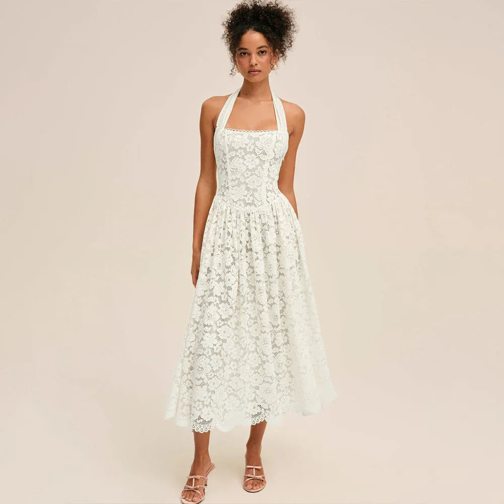 Woman wearing a white lace halter midi dress, front view