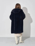 Back view of woman in black hooded faux fur coat