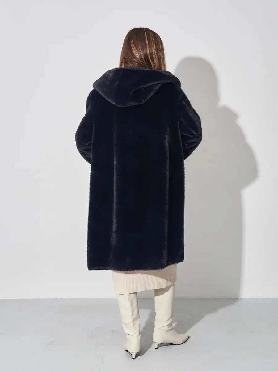 Back view of woman in black hooded faux fur coat