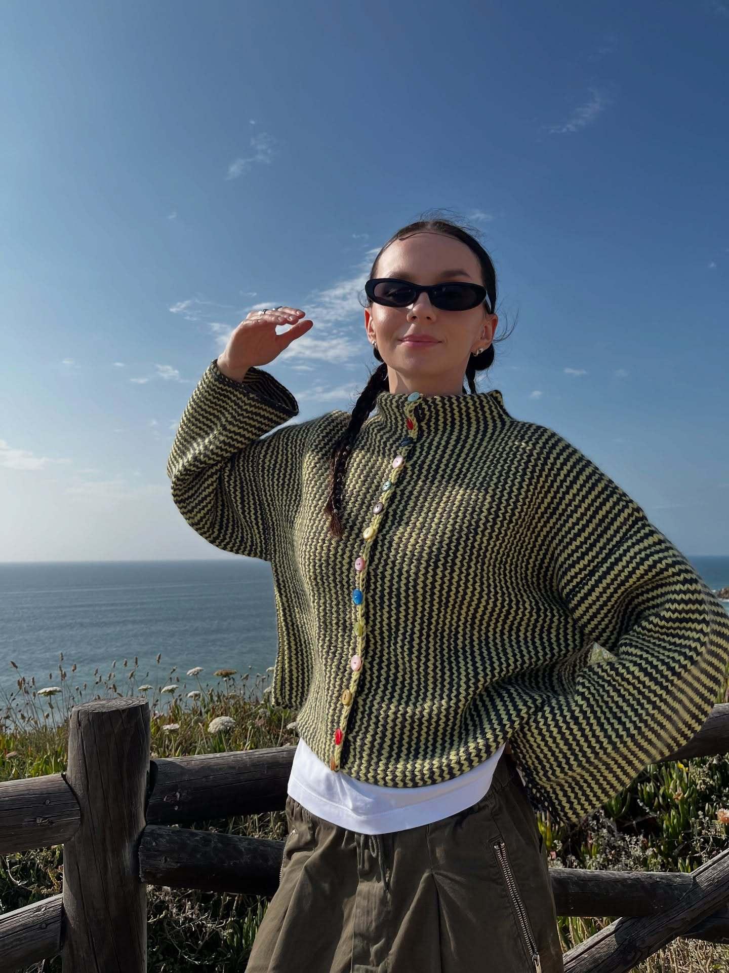 Back view of a woman in a textured knit cardigan with colorful buttons