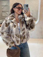 Woman wearing a brown and white patterned faux fur jacket with blue jeans