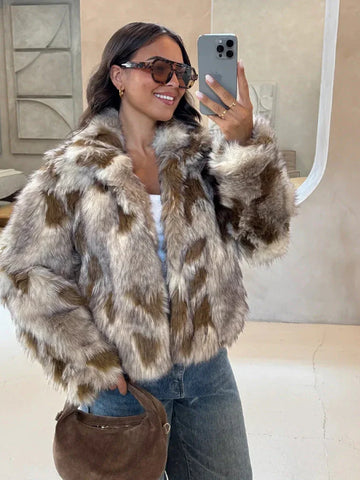 Woman wearing a brown and white patterned faux fur jacket with blue jeans