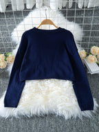 Navy blue cropped knit sweater with a white intarsia bow graphic on the front, long sleeves, and ribbed cuffs and hem. - View 6 | WEUXS