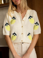 Front view of a cream knit cardigan with a lemon print