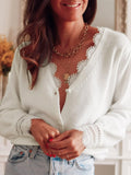 Woman in a white lace-trimmed cardigan and jeans