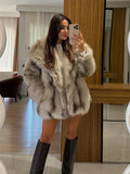Front view of a woman in a fluffy faux fur coat.