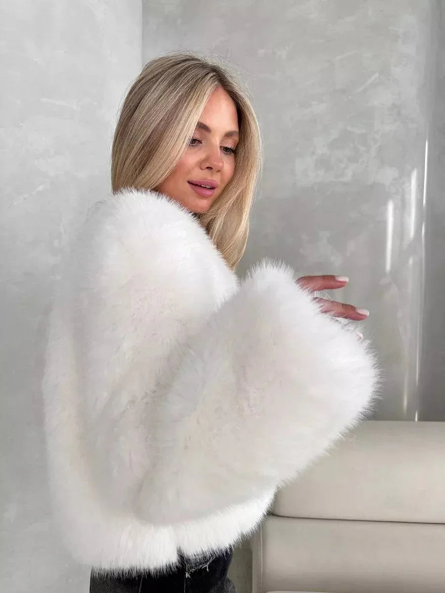 Close-up of a woman in a white faux fur jacket, showcasing the texture of the material.