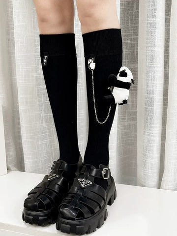 Black knee-high socks with a panda charm and chain detail.