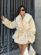 Cream faux fur coat with a textured finish and a wide lapel.