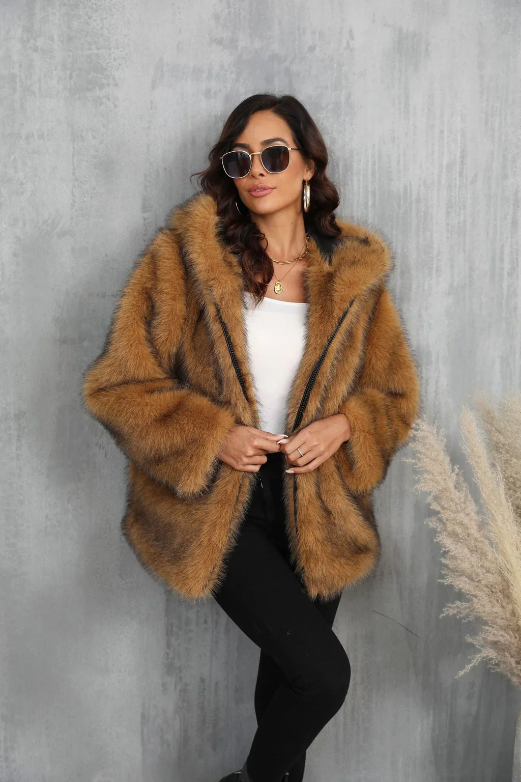 Woman wearing a brown faux fur hooded jacket
