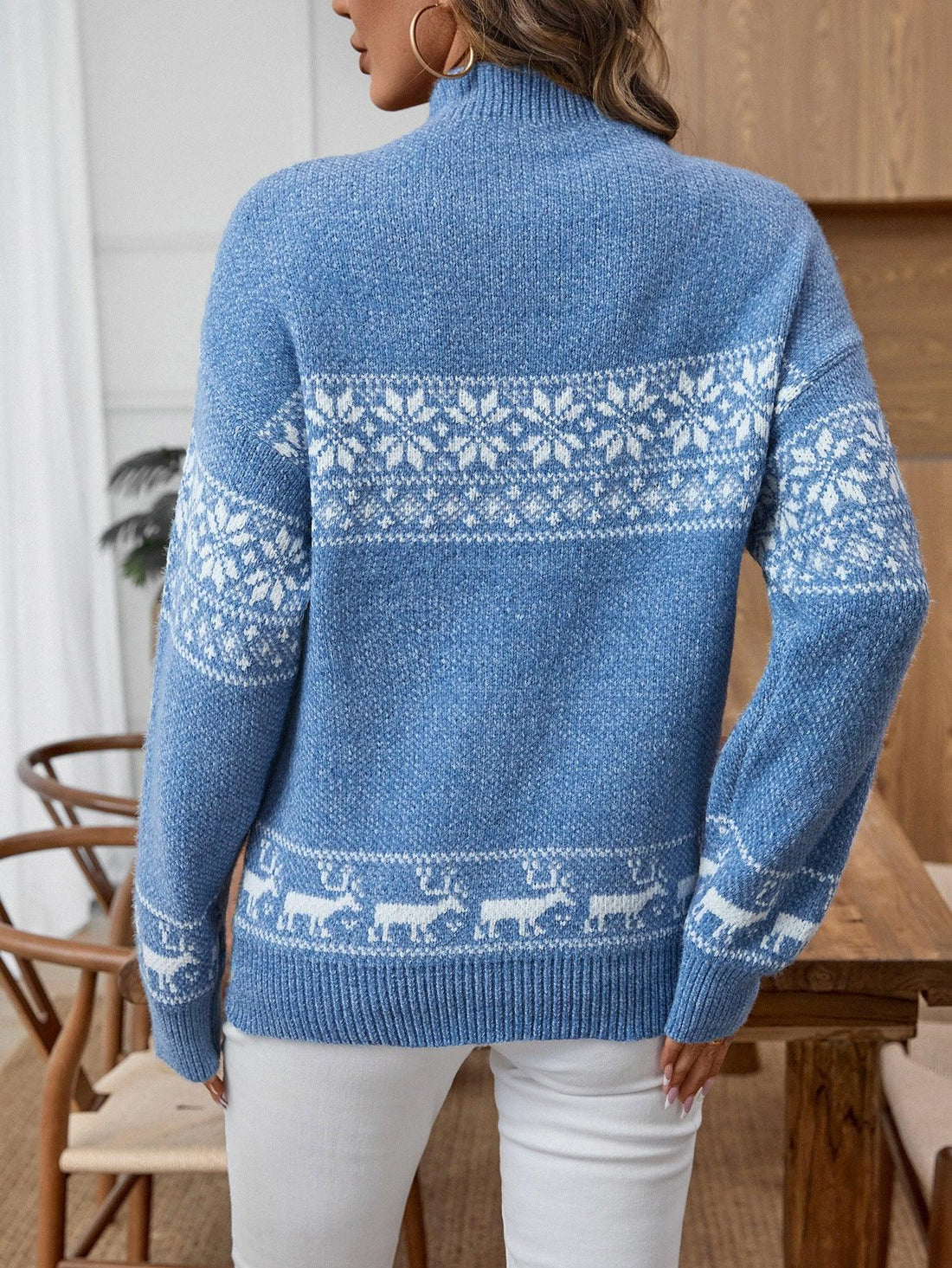 Woman wearing a blue Nordic snowflake mock neck sweater